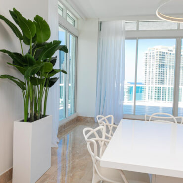 Jort Slim Medium Planter in Glossy White with Bird of Paradise